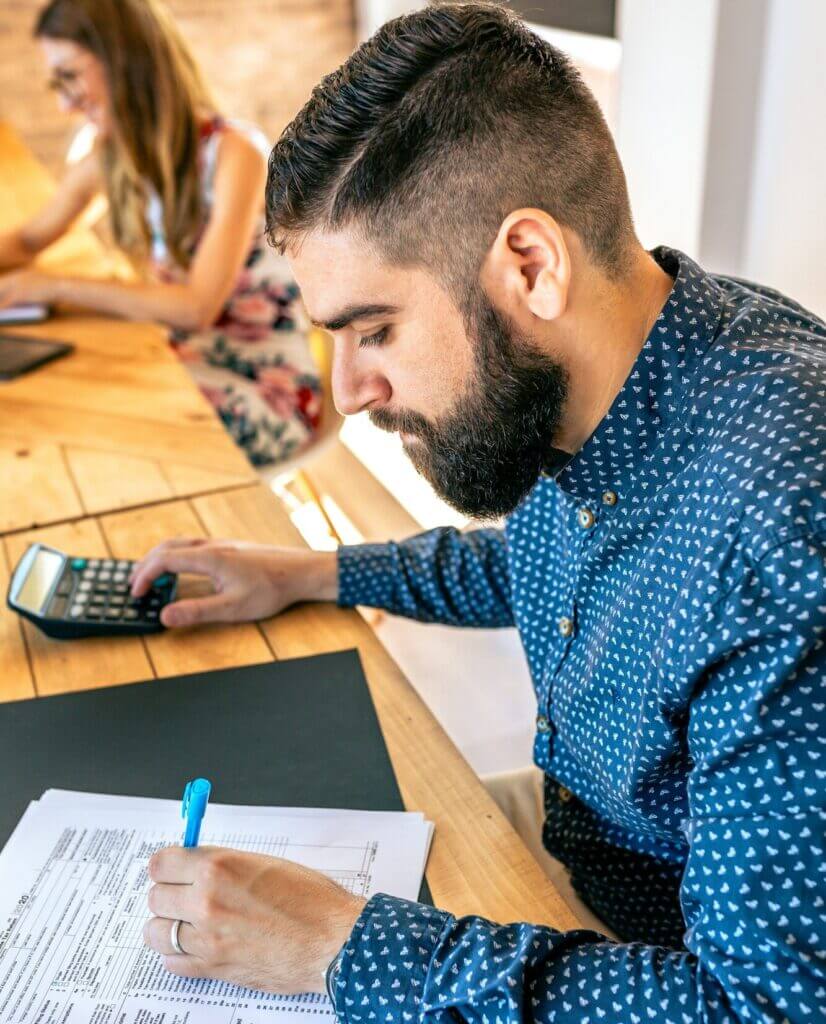 Adviser filling in tax documents in office