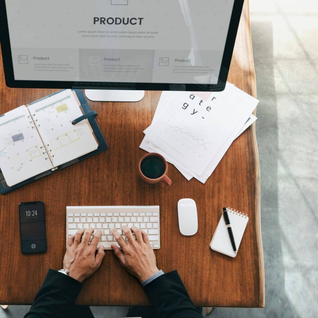 Busy businessman using a computer to plan a new product