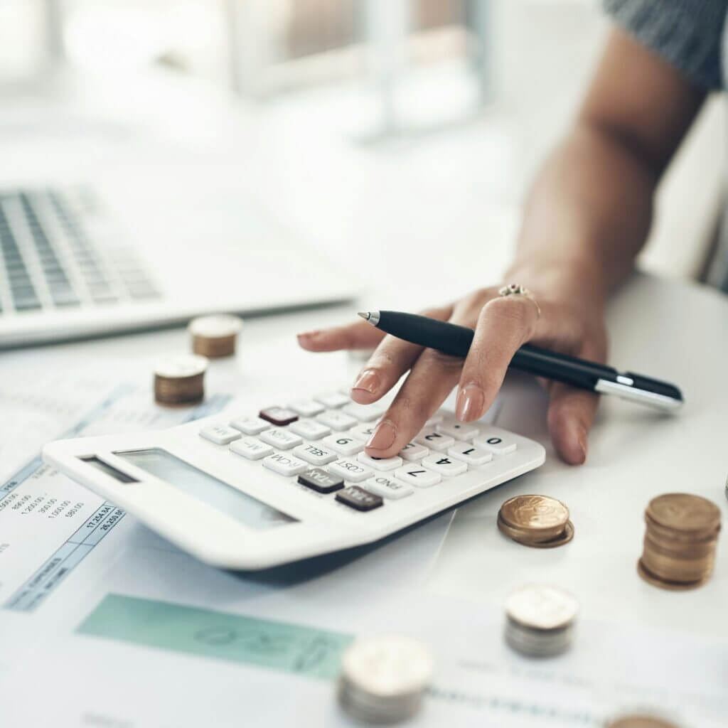 Closeup shot of an unrecognisable businesswoman calculating finances in an office